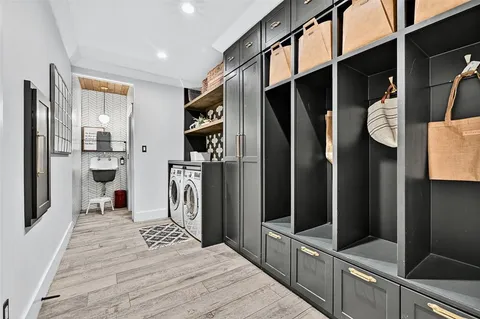 a kitchen with stainless steel appliances a refrigerator and a wooden floor
