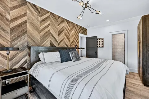 a bedroom with a bed and a chandelier