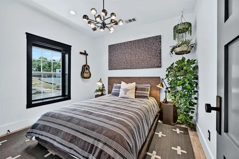 a bedroom with a bed and a chandelier