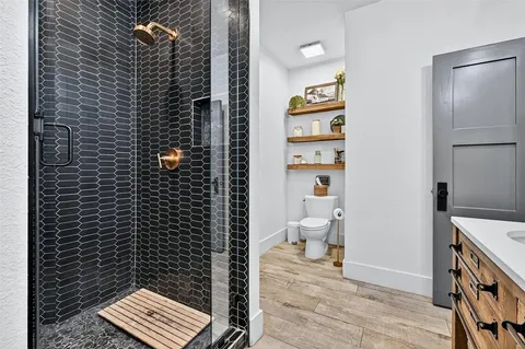 a bathroom with a toilet and a shower