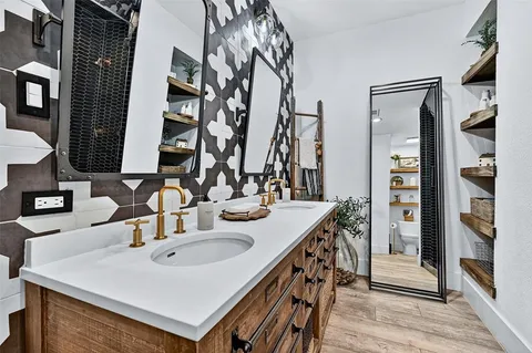 a kitchen with stainless steel appliances a sink and a refrigerator