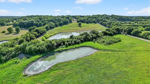 a view of a street with a garden