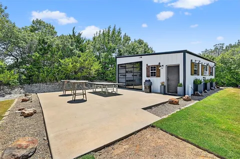 a view of a house with backyard and sitting area