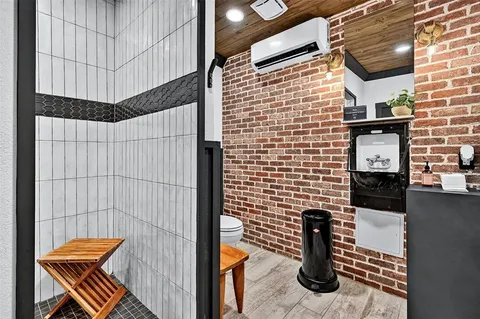 swimming view of a house with backyard porch and sitting area