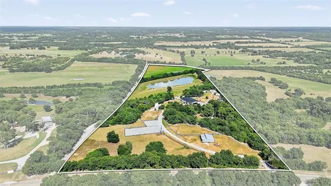 an aerial view of a house with swimming pool garden and patio