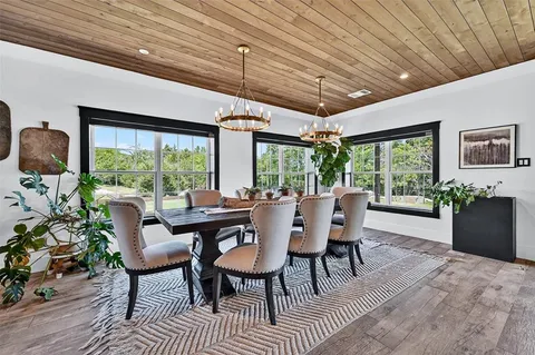 a dining room with furniture window and outside view