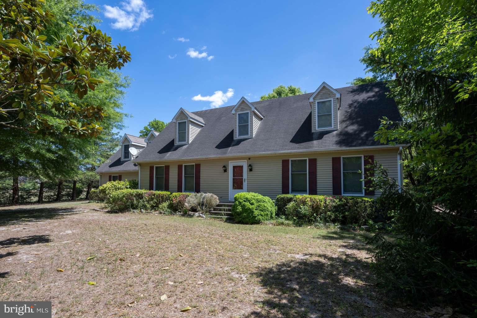 37186 Clubhouse Road Ocean View, DE 19970 - Photo 8 of 14 a front view of house with yard and trees around
