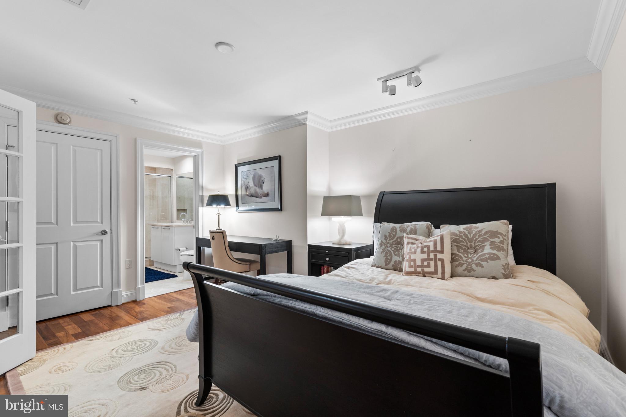 801 Key Highway, Unit 441 Baltimore, MD 21230 - Photo 30 of 46 a bedroom with a bed and wooden floor