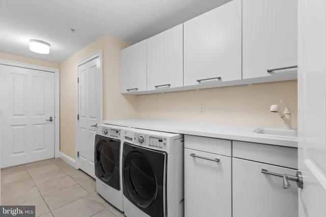 a view of a storage and utility room with washer and dryer