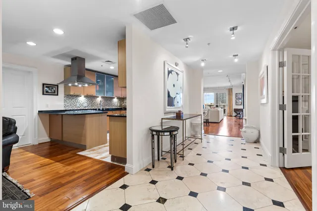 a kitchen with stainless steel appliances kitchen island granite countertop a sink and cabinets
