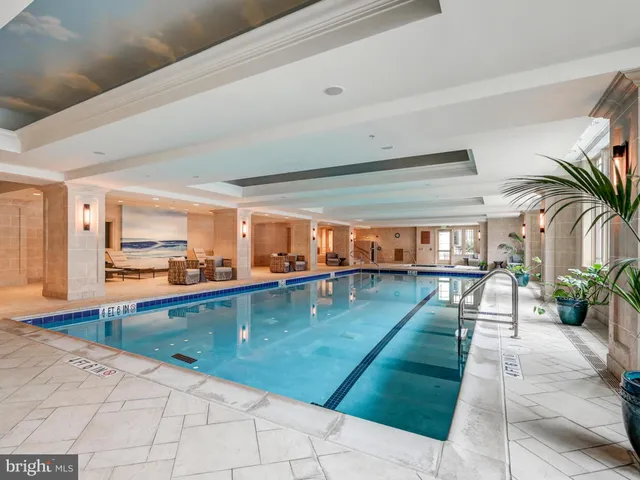 a swimming pool with outdoor seating and yard