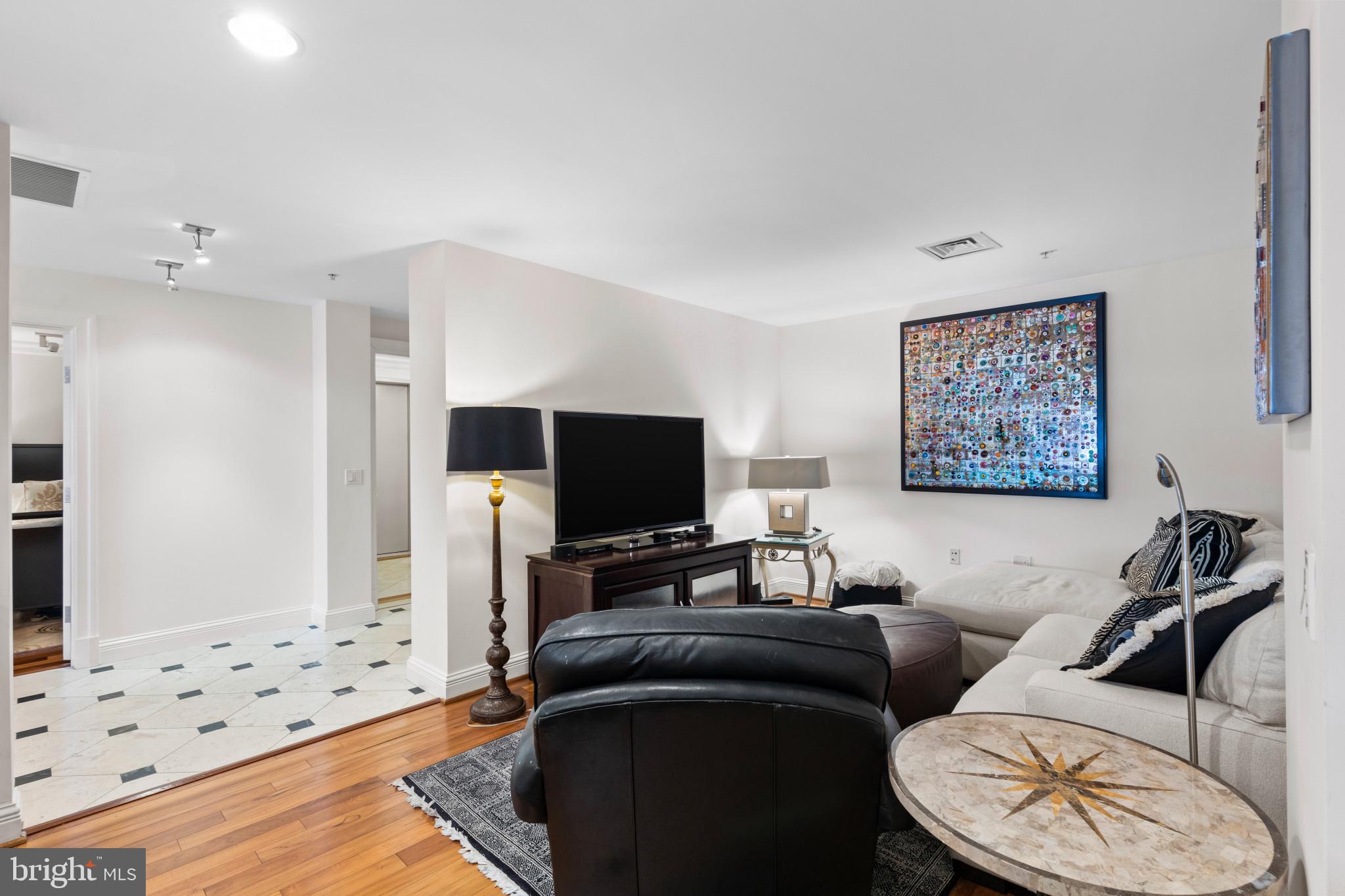 801 Key Highway, Unit 441 Baltimore, MD 21230 - Photo 5 of 46 a living room with furniture and a flat screen tv