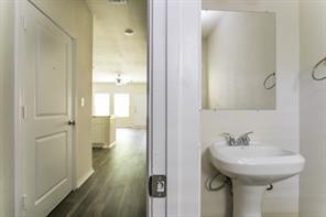 690 Union Street, Unit 1 Bonham, TX 75418 - Photo 15 of 15 Half bathroom with dark wood-style flooring