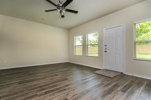 690 Union Street, Unit 1 Bonham, TX 75418 - Photo 6 of 15 Foyer entrance featuring dark wood-type flooring and a ceiling fan