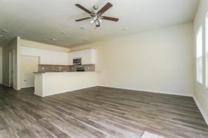 690 Union Street, Unit 1 Bonham, TX 75418 - Photo 7 of 15 Unfurnished living room featuring dark wood-type flooring and ceiling fan