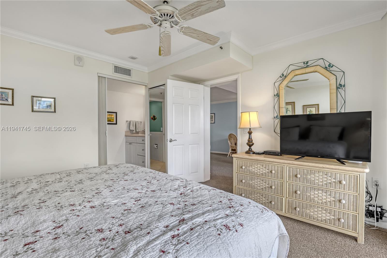 701 South Seas Drive, Unit 206 Jupiter, FL 33477 - Photo 13 of 19 a bedroom with a bed and a flat screen tv in white walls