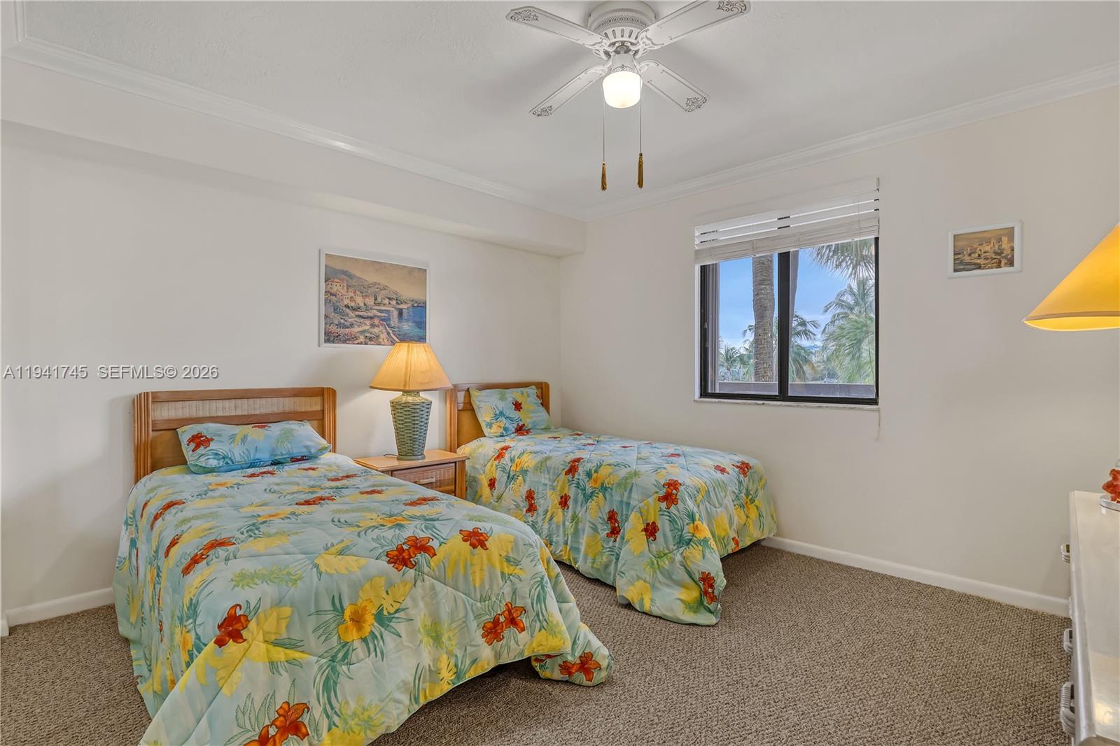 701 South Seas Drive, Unit 206 Jupiter, FL 33477 - Photo 16 of 19 a bedroom with two beds and a chandelier