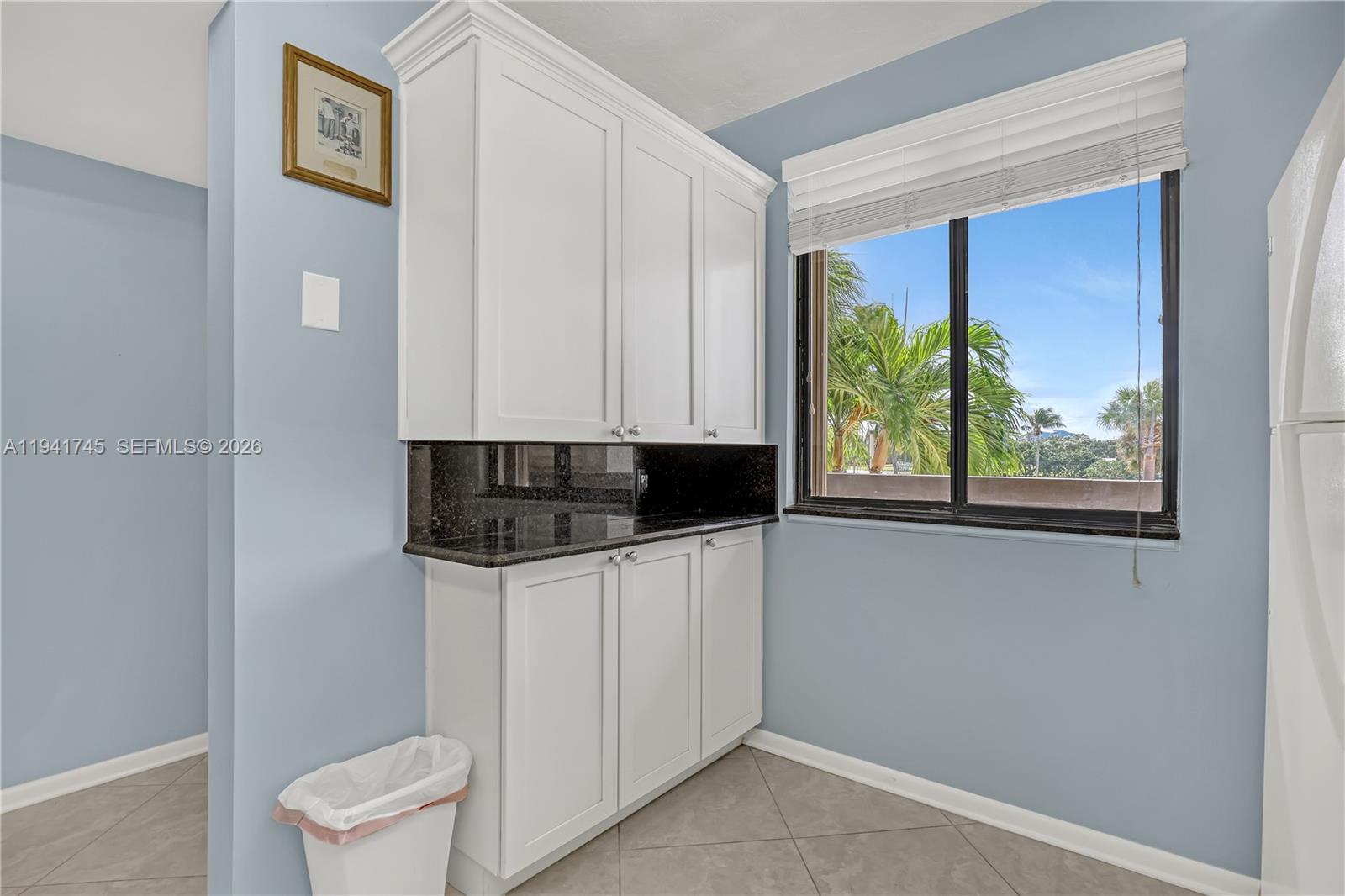 701 South Seas Drive, Unit 206 Jupiter, FL 33477 - Photo 9 of 19 a kitchen with a refrigerator and a window