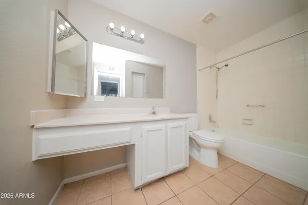 an empty room with a window and a ceiling fan