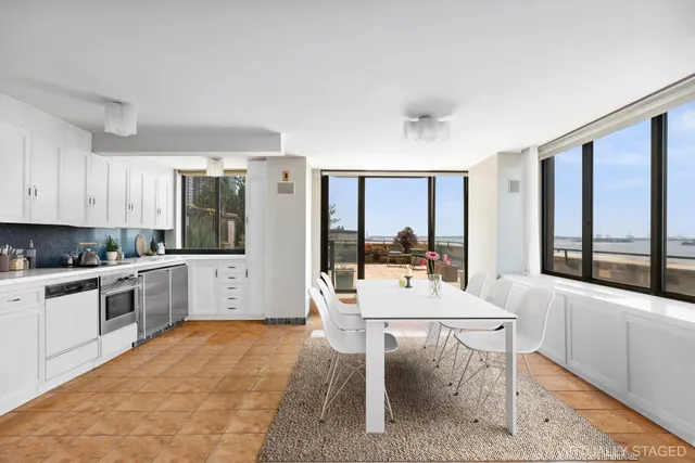 a kitchen with a table chairs sink and cabinets