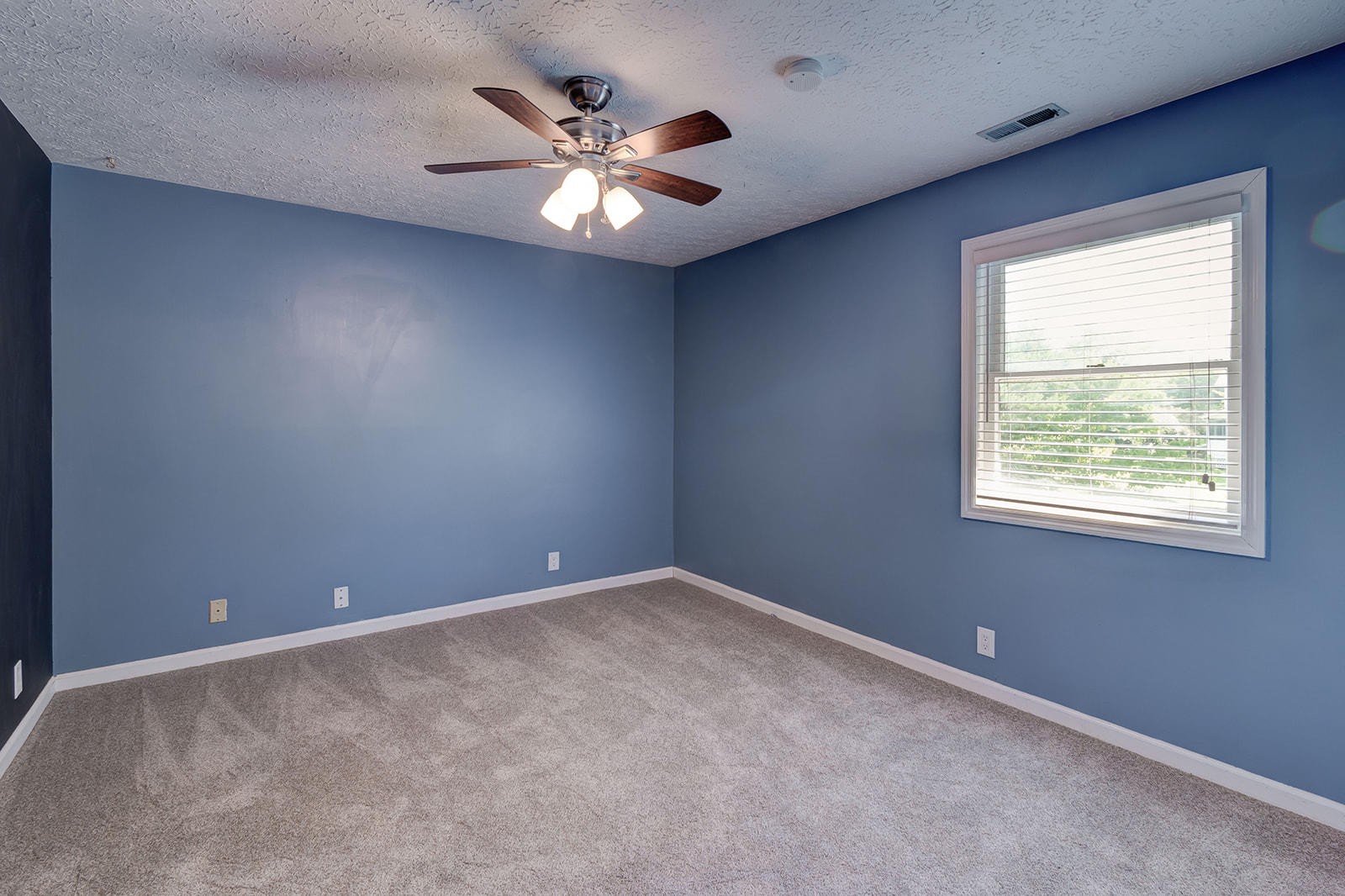 502 Rolling Creek Road Knoxville, TN 37934 - Photo 18 of 27 an empty room with a chandelier fan and windows