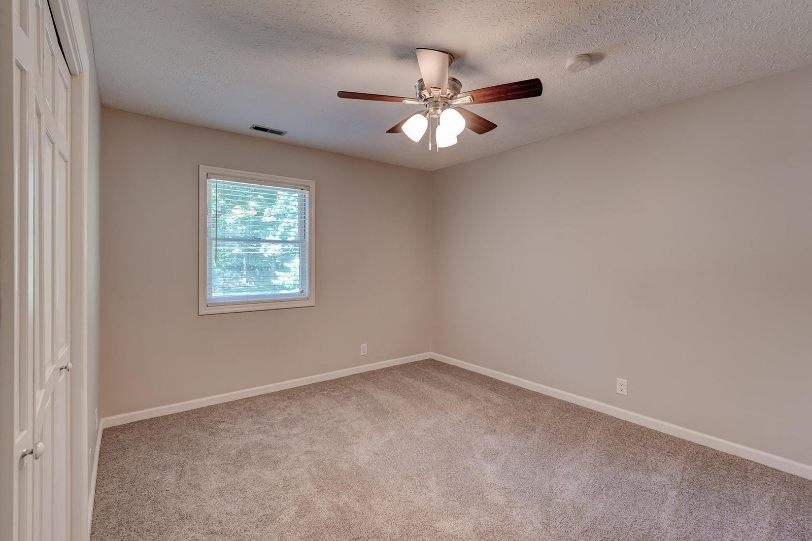 502 Rolling Creek Road Knoxville, TN 37934 - Photo 19 of 27 an empty room with a window and a fan