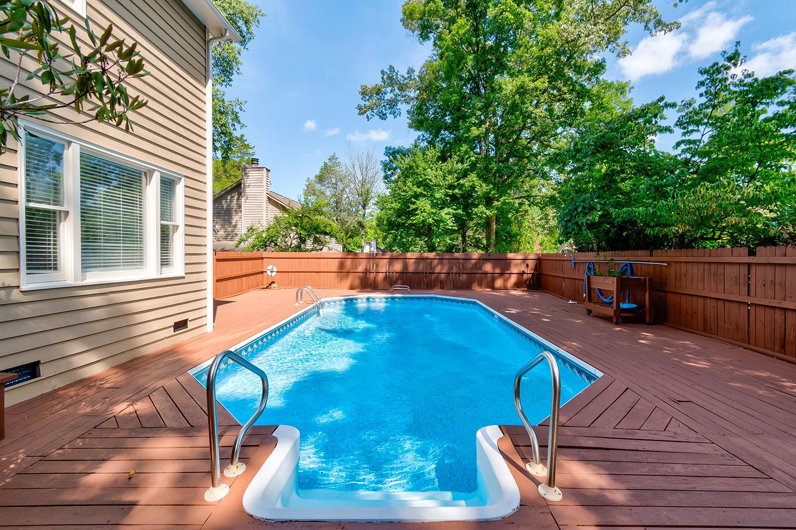 502 Rolling Creek Road Knoxville, TN 37934 - Photo 24 of 27 a view of a backyard with table and chairs potted plants and wooden fence