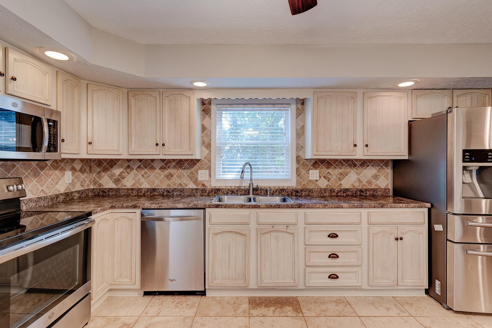502 Rolling Creek Road Knoxville, TN 37934 - Photo 8 of 27 a kitchen with white cabinets stainless steel appliances and sink