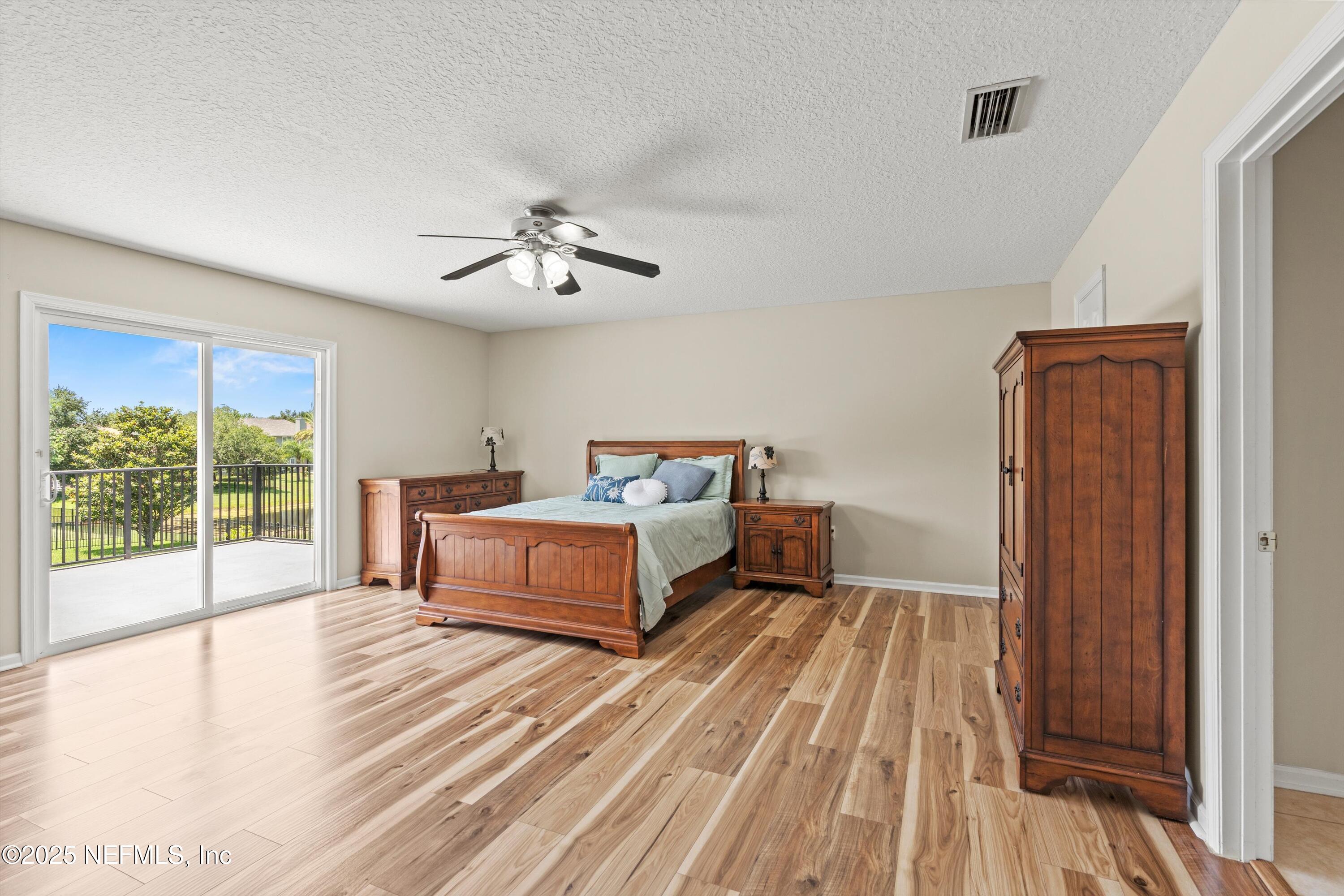 2360 Golfview Drive Fleming Island, FL 32003 - Photo 17 of 60 a spacious bedroom with a bed and a large window