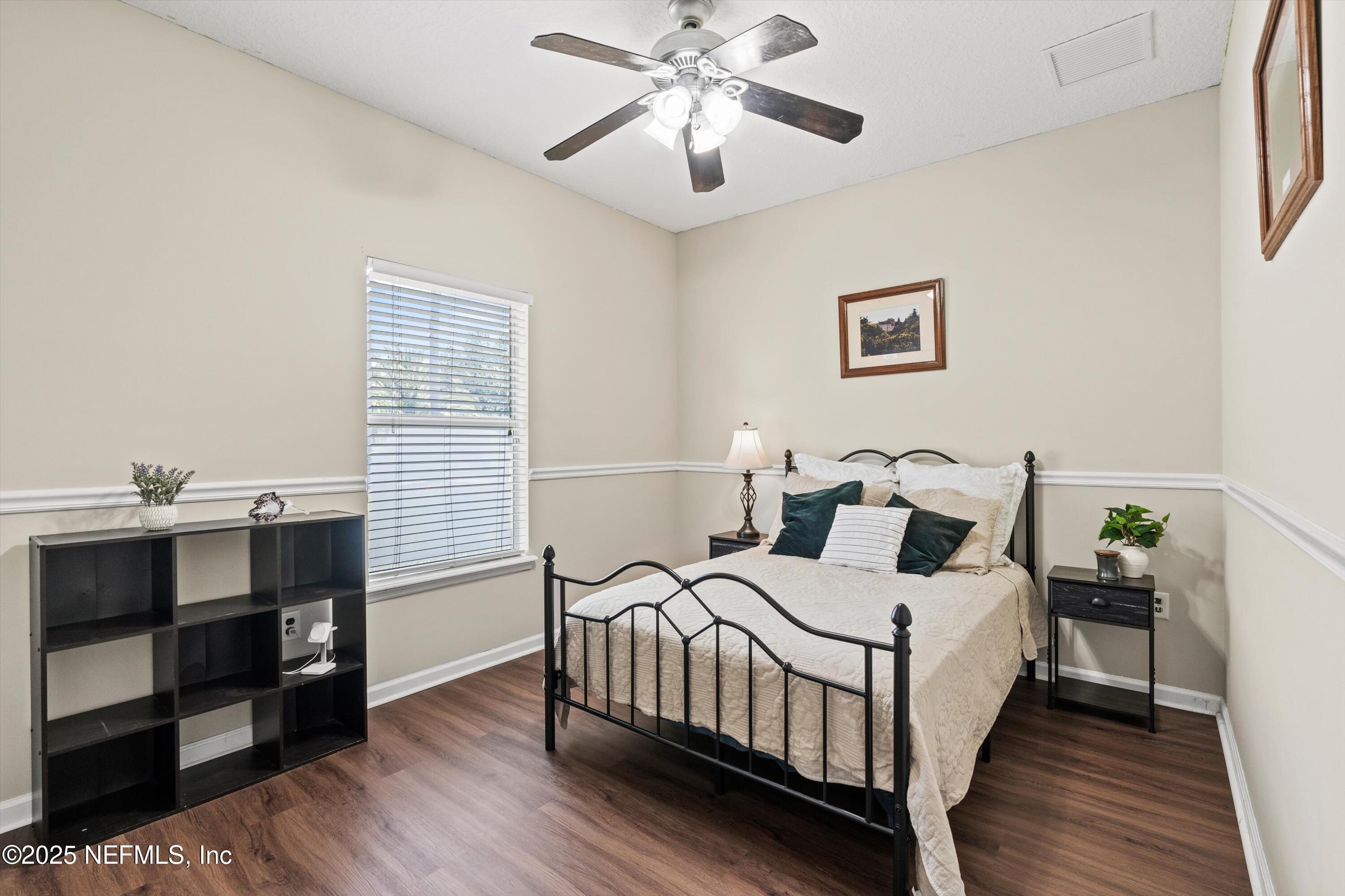 2360 Golfview Drive Fleming Island, FL 32003 - Photo 21 of 60 a bedroom with a bed and wooden floor