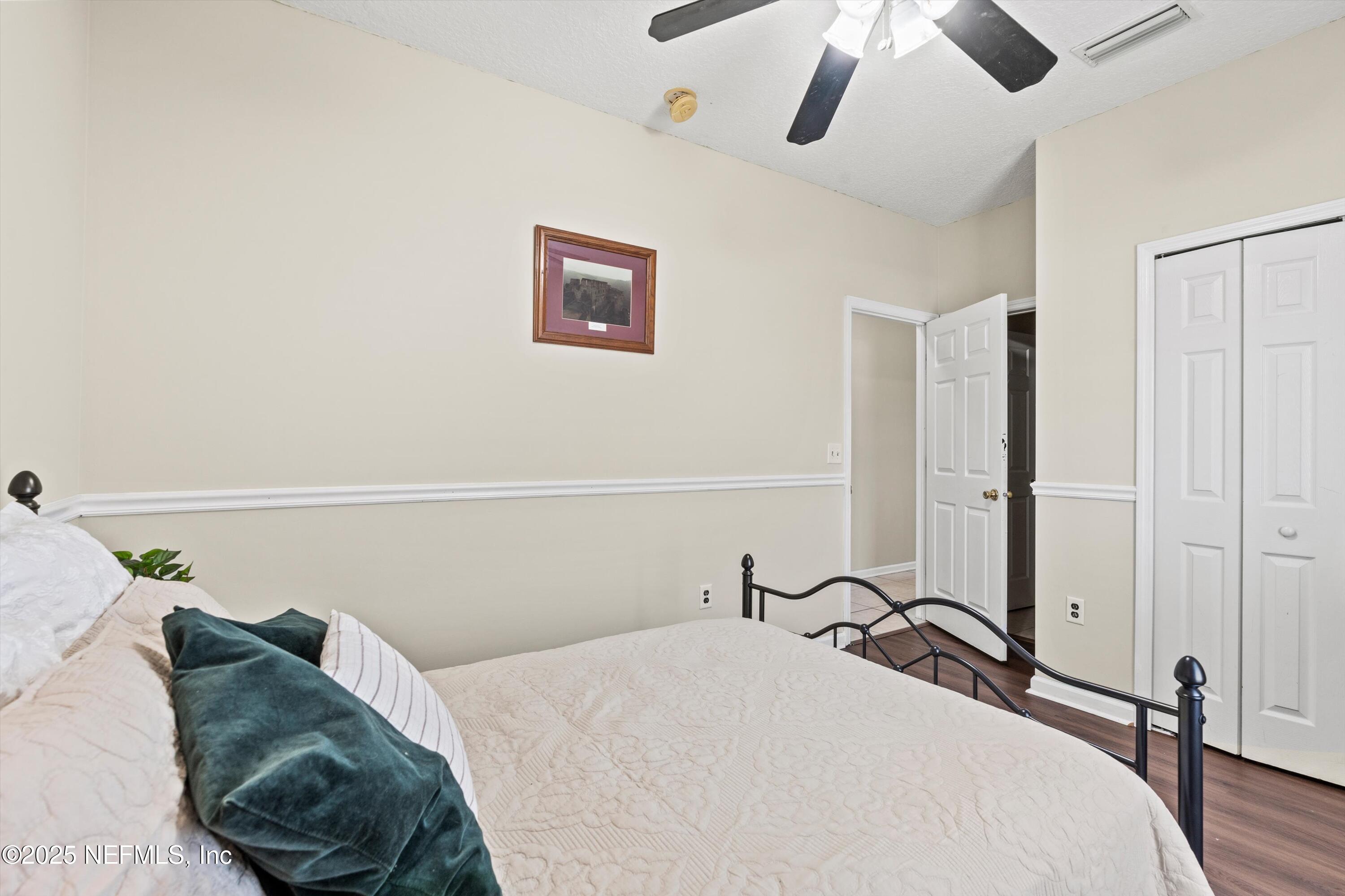 2360 Golfview Drive Fleming Island, FL 32003 - Photo 22 of 60 a bedroom with a bed and a chandelier