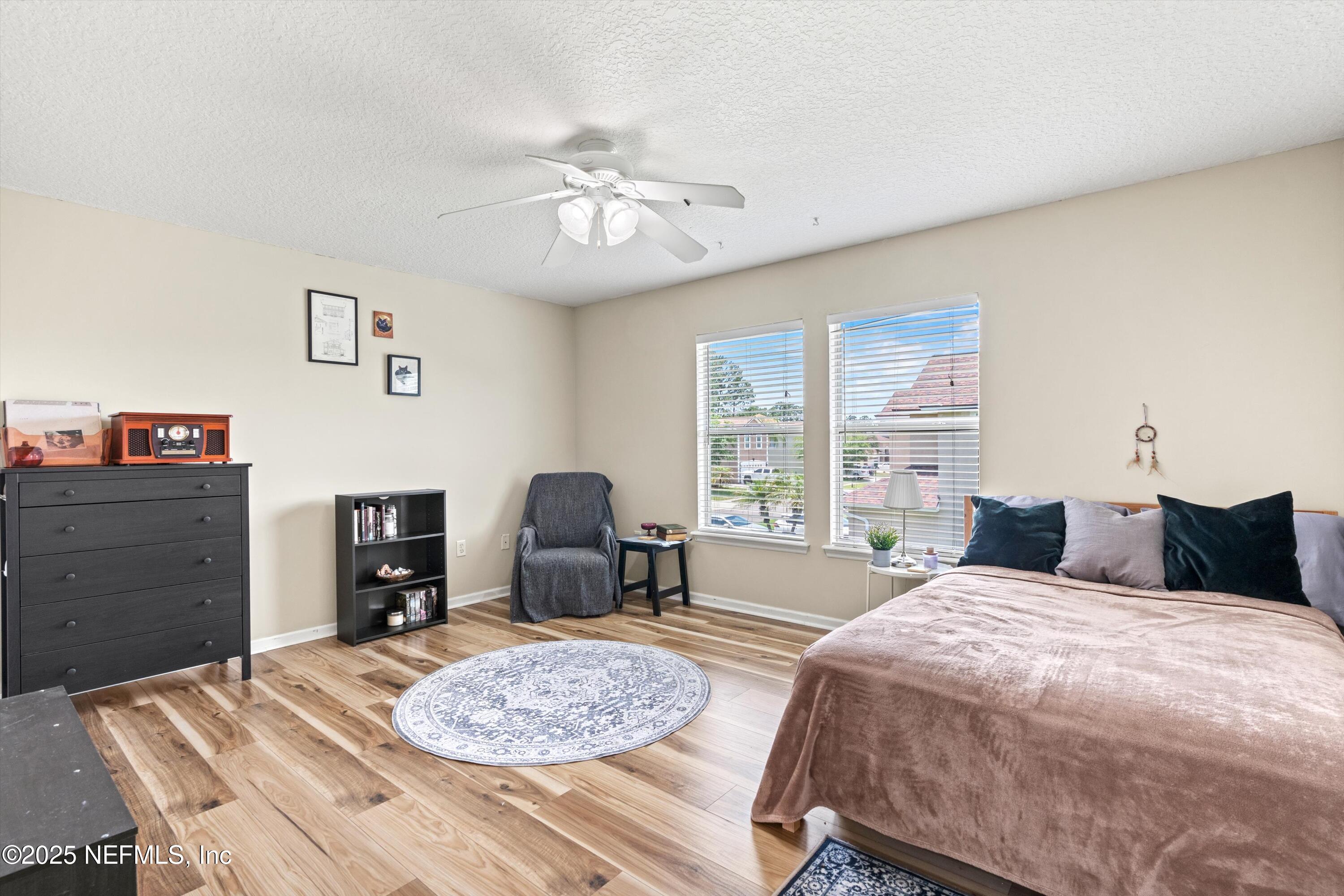 2360 Golfview Drive Fleming Island, FL 32003 - Photo 24 of 60 a bedroom with a bed and dresser with chair