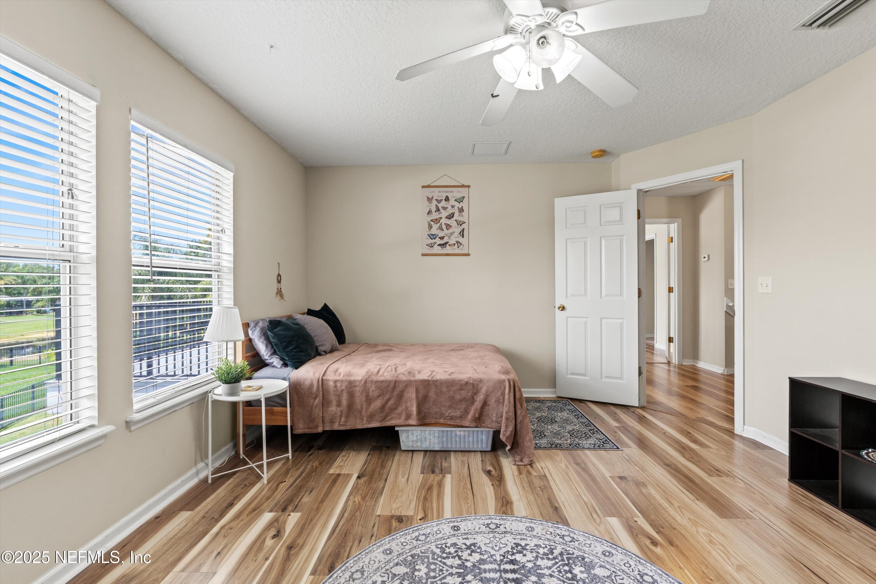2360 Golfview Drive Fleming Island, FL 32003 - Photo 25 of 60 a bedroom with a bed and a flat tv screen on dresser