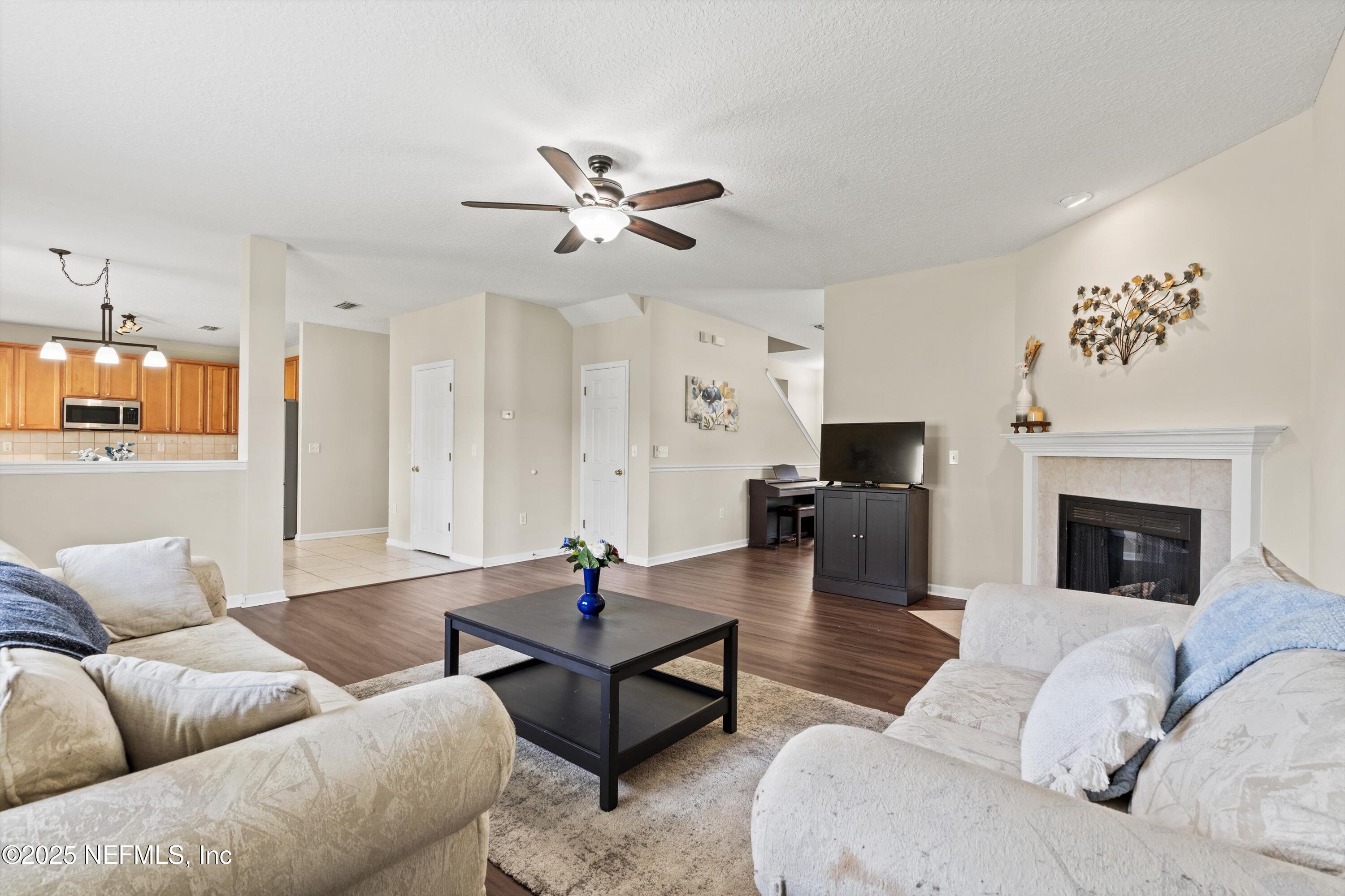 2360 Golfview Drive Fleming Island, FL 32003 - Photo 32 of 60 a living room with furniture and a fireplace