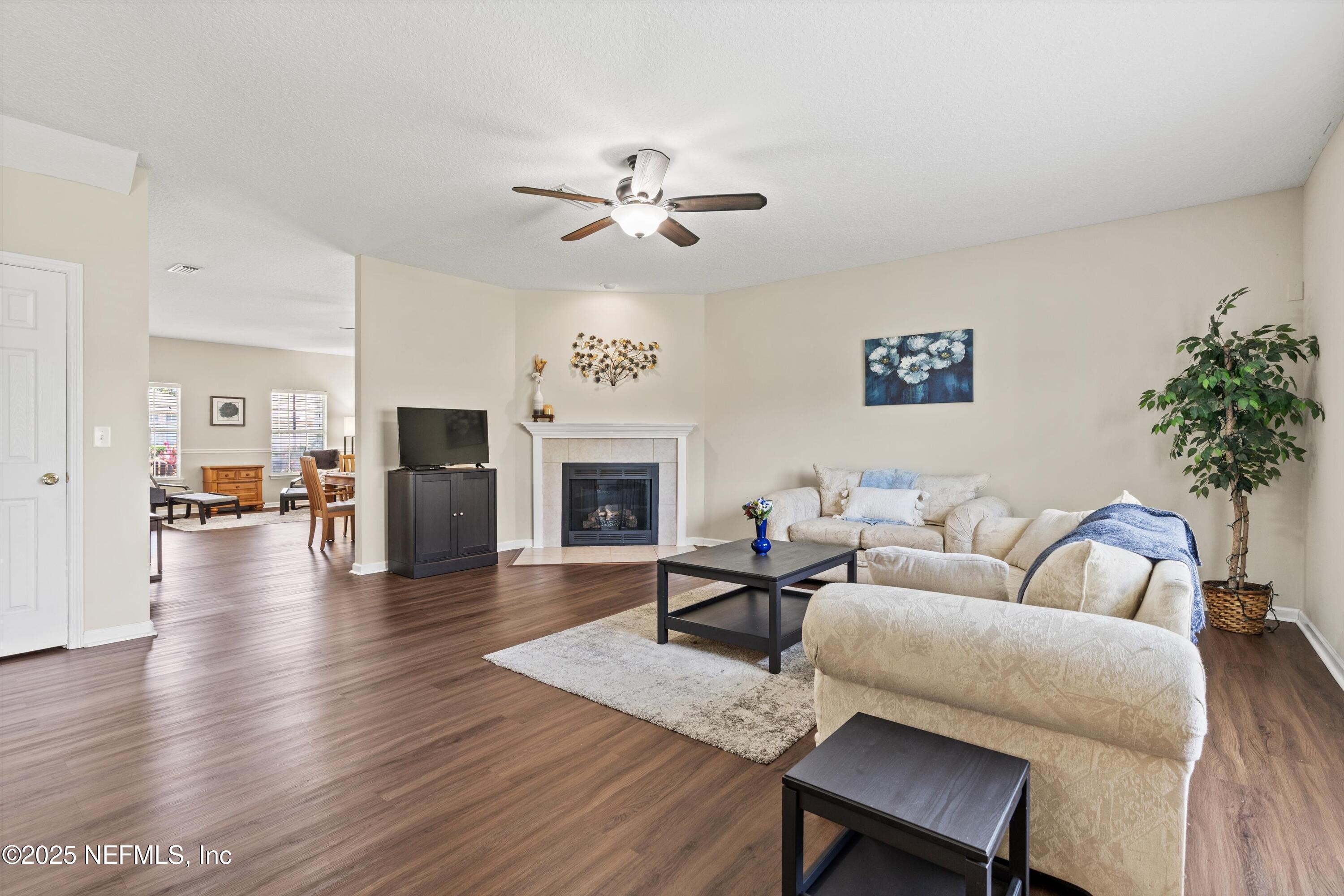 2360 Golfview Drive Fleming Island, FL 32003 - Photo 5 of 60 a living room with furniture a fireplace and a flat screen tv