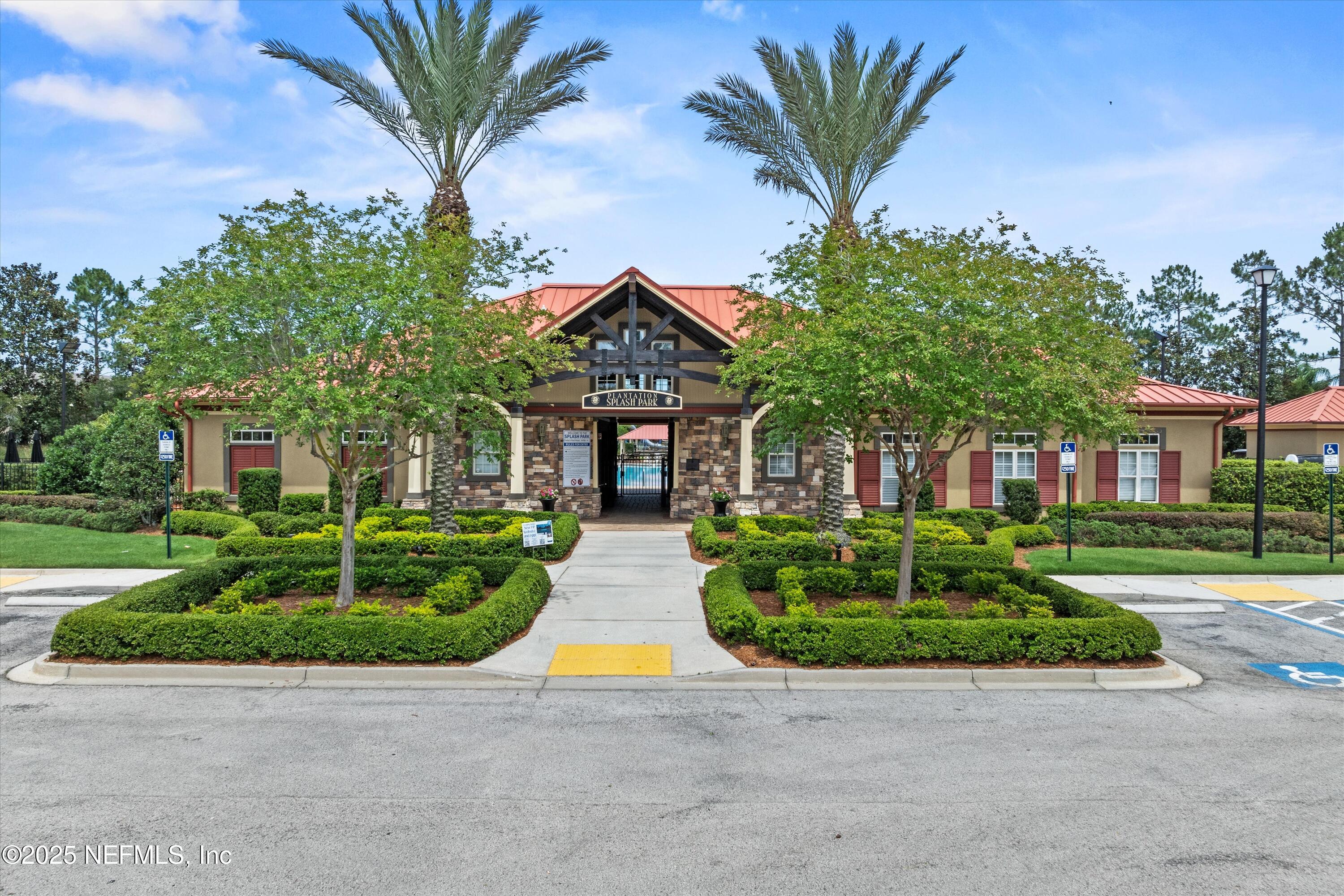 2360 Golfview Drive Fleming Island, FL 32003 - Photo 54 of 60 a front view of a house with a garden and trees