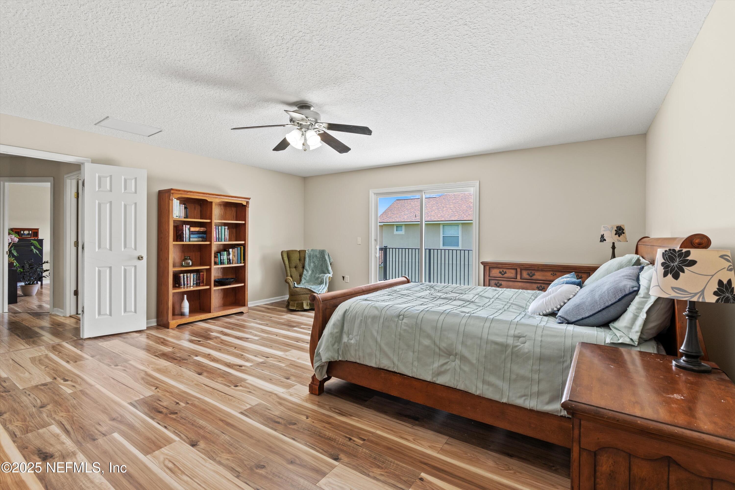 2360 Golfview Drive Fleming Island, FL 32003 - Photo 7 of 60 a bedroom with a bed and a chandelier