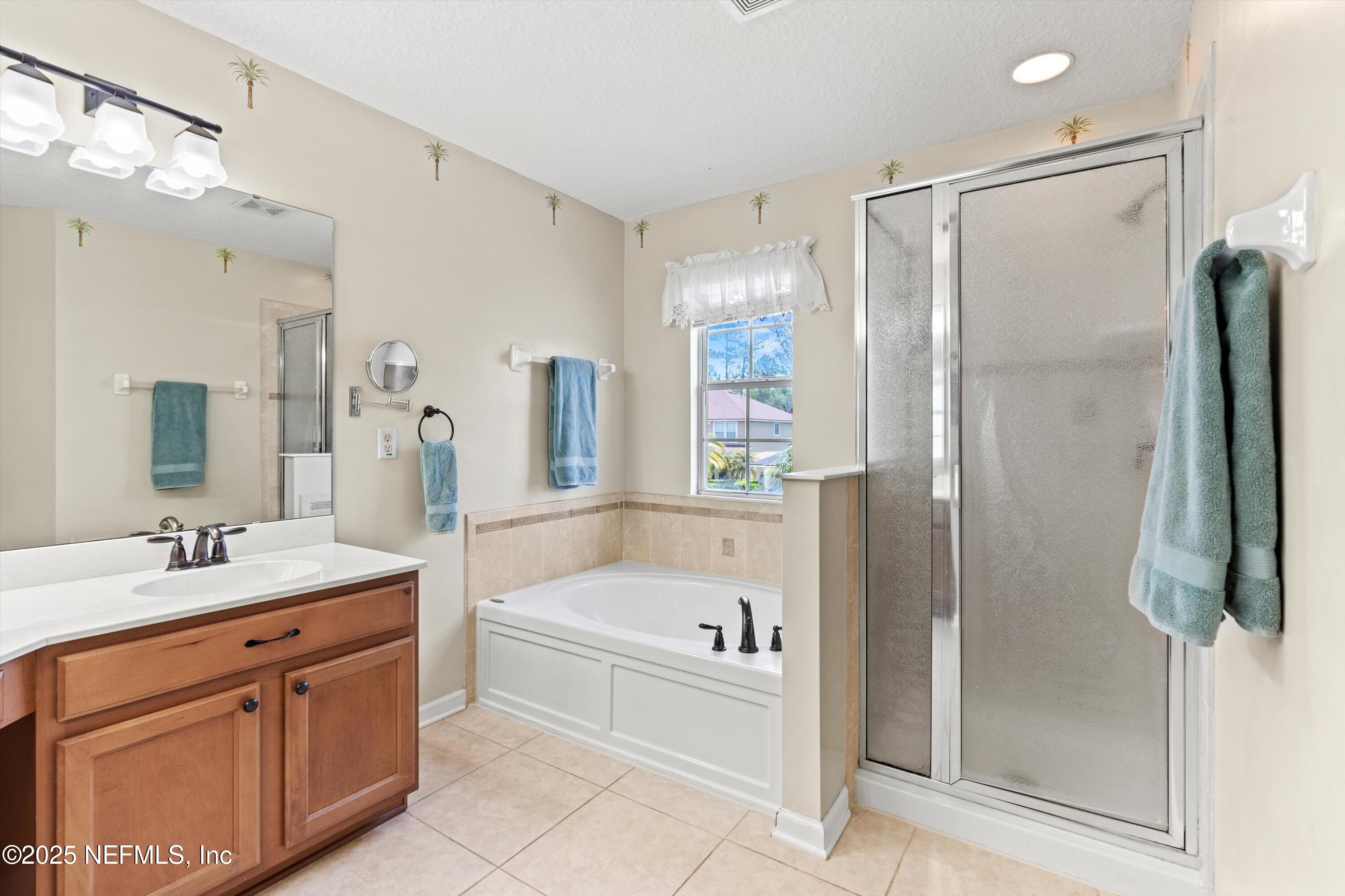 2360 Golfview Drive Fleming Island, FL 32003 - Photo 9 of 60 a bathroom with a tub sink shower and mirror