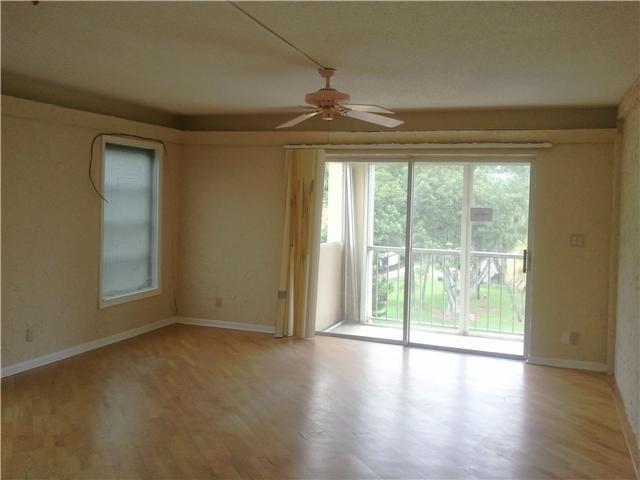 950 Ponce De Leon Road, Unit 412 Boca Raton, FL 33432 - Photo 3 of 6 a view of empty room with wooden floor and fan