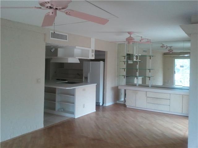 950 Ponce De Leon Road, Unit 412 Boca Raton, FL 33432 - Photo 5 of 6 a open kitchen with white cabinets and stainless steel appliances