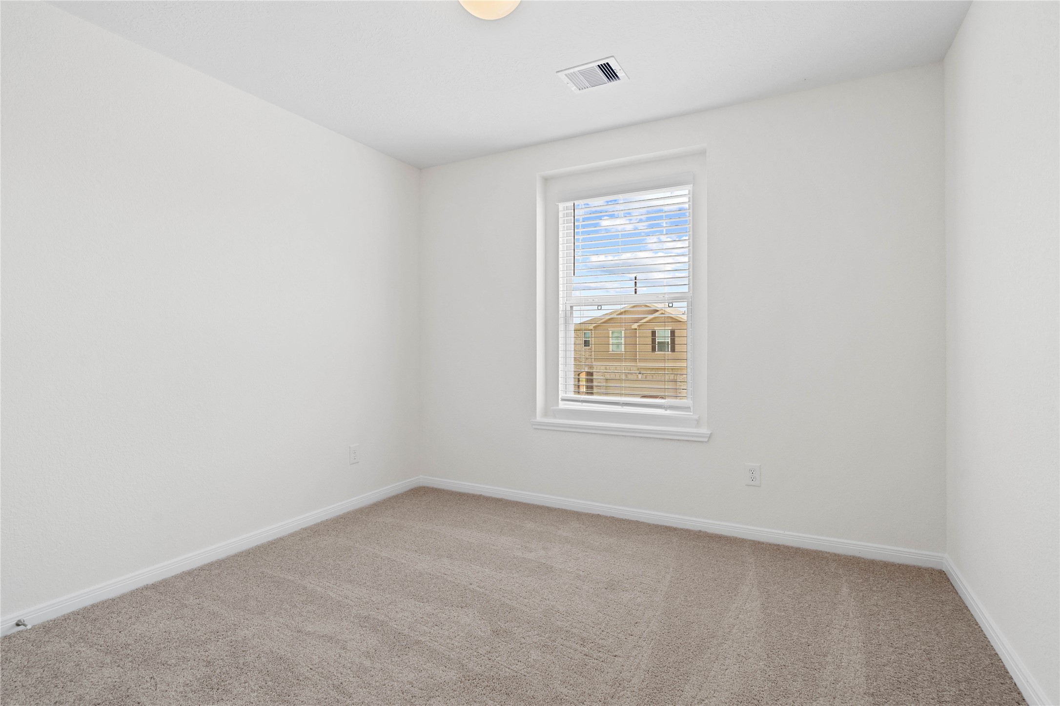 6418 Kentfield Drive Rosharon, TX 77583 - Photo 16 of 23 This secondary bedroom offers comfort and style with plush carpeting, neutral paint tones, globe lighting, a large window with blinds, and a generously sized closet.