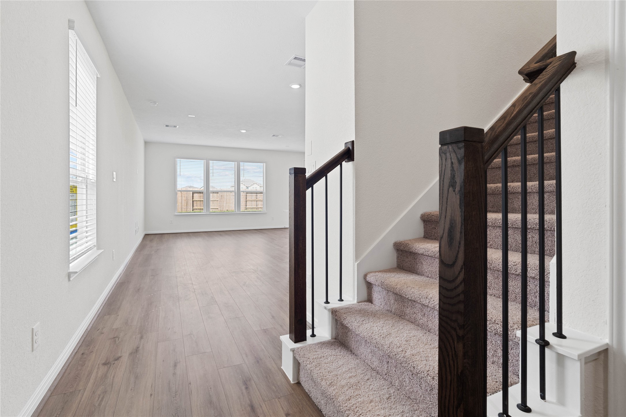6418 Kentfield Drive Rosharon, TX 77583 - Photo 4 of 23 Step inside your new home, where the Layton Lake vinyl plank flooring, gorgeous stairway, and fresh, bright paint create a warm and inviting entryway.