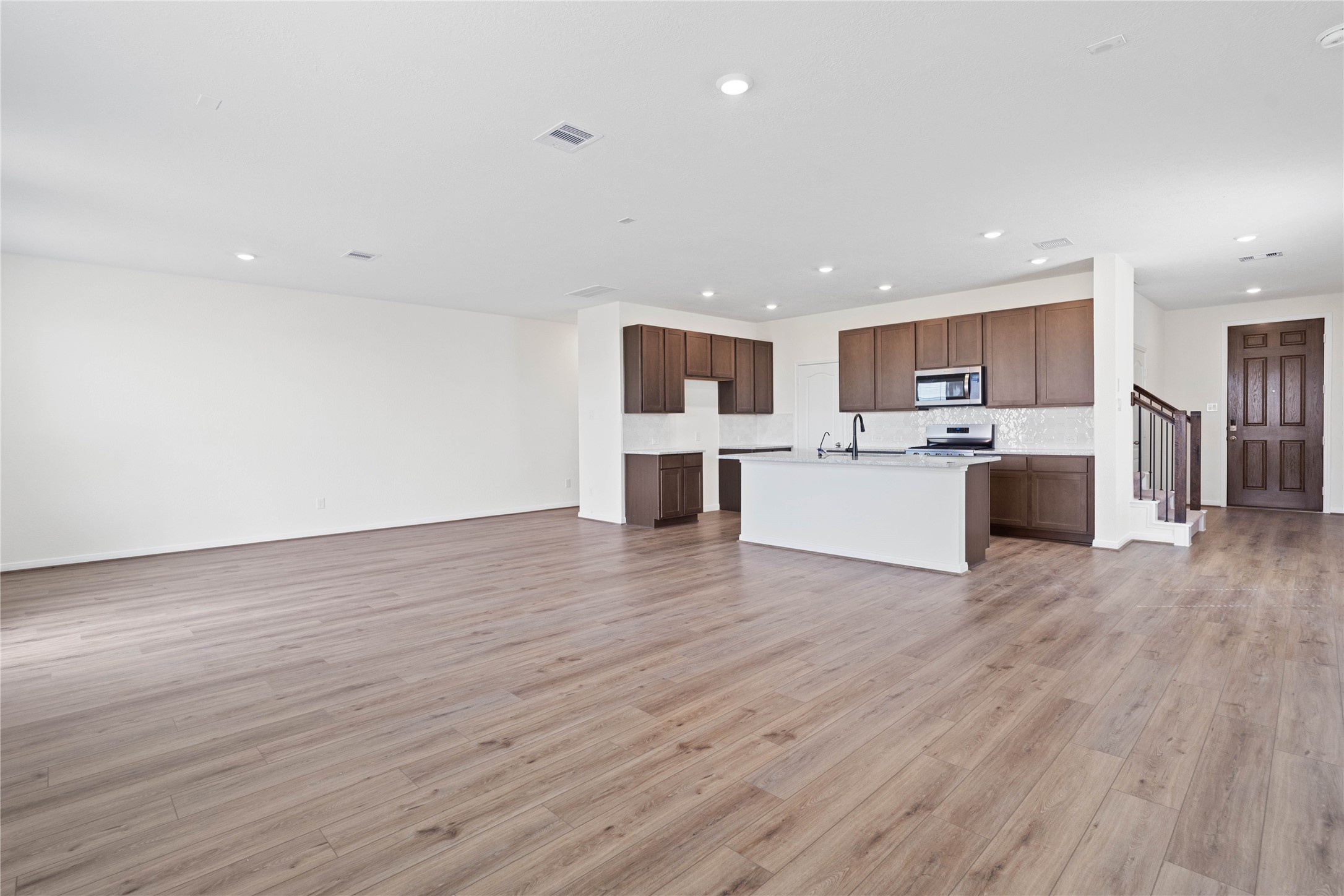 6418 Kentfield Drive Rosharon, TX 77583 - Photo 10 of 23 Stunning open-concept design seamlessly connecting the living, dining, and kitchen areas—perfect for both everyday living and entertaining!