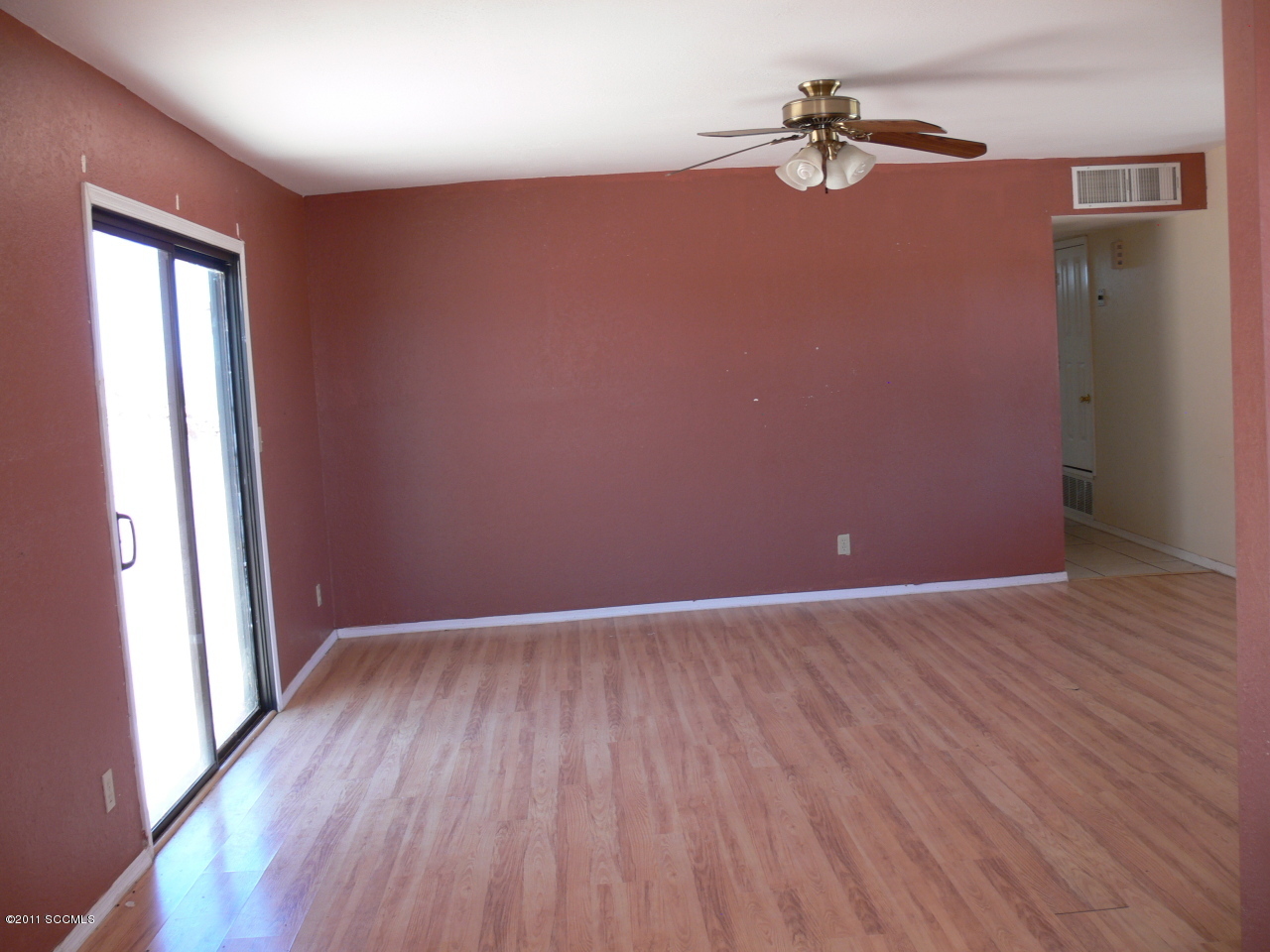 929 Via Puebla Rio Rico, AZ 85648 - Photo 3 of 13 an empty room with wooden floor fan and windows