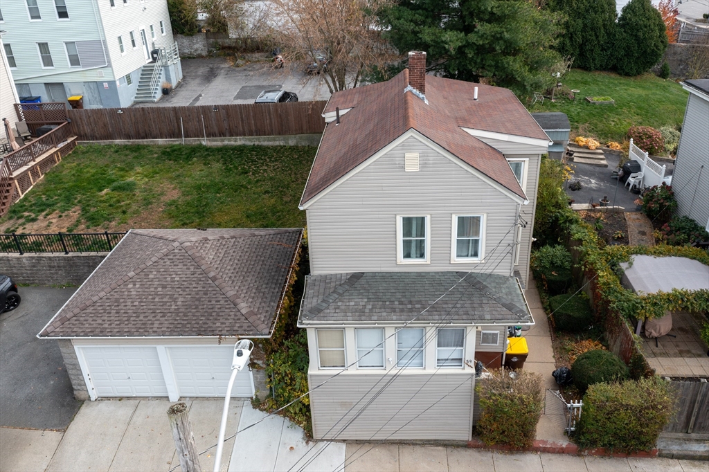 89 Oak Street Fall River, MA 02720 - Photo 3 of 39 a aerial view of a house with a yard and potted plants