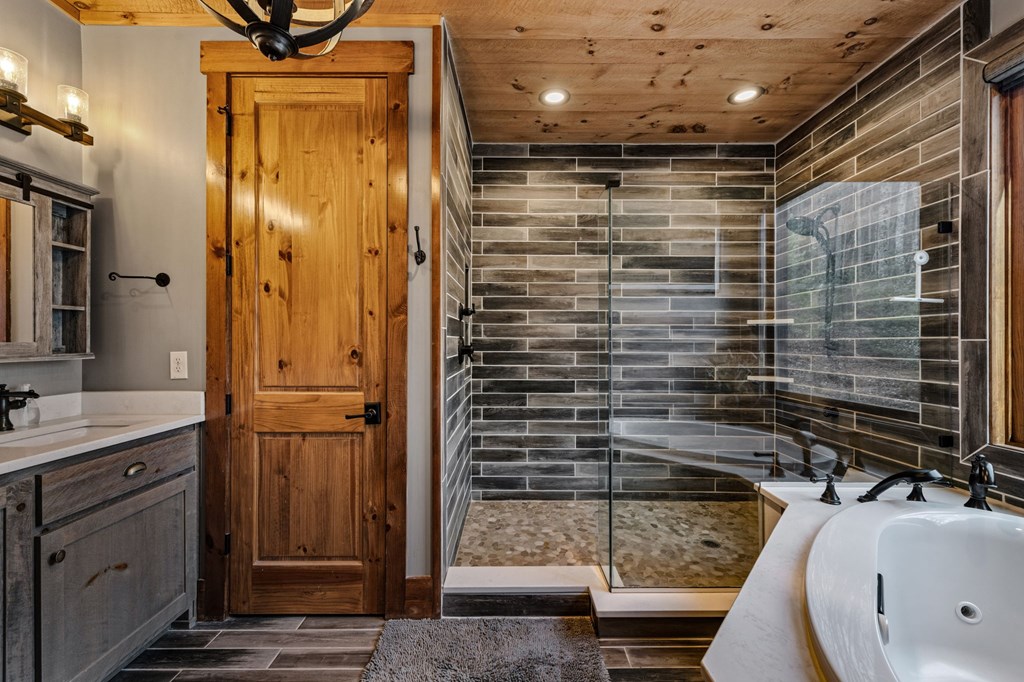 287 Scouts Overlook Lane Morganton, GA 30560 - Photo 32 of 84 a bathroom with a shower and a sink