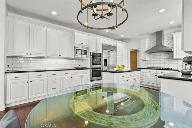 a kitchen with stainless steel appliances kitchen island granite countertop a sink and cabinets
