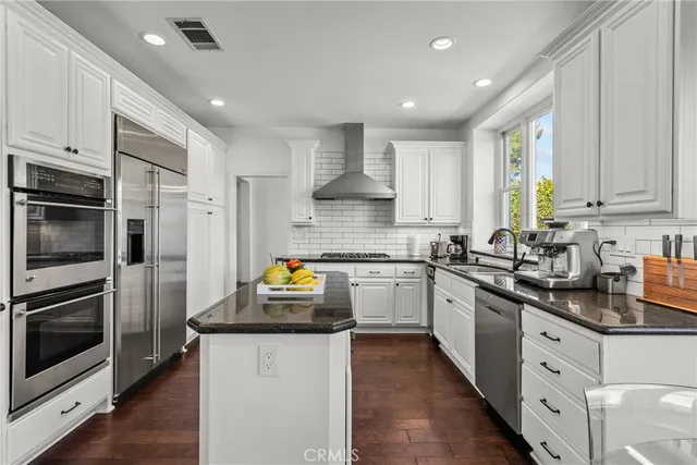 a kitchen with a refrigerator and a sink