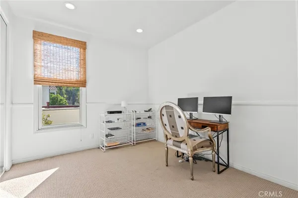 a spacious bedroom with a bed and a large window