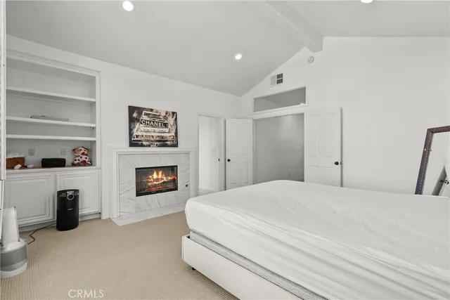 a front view of a house with a yard and potted plants